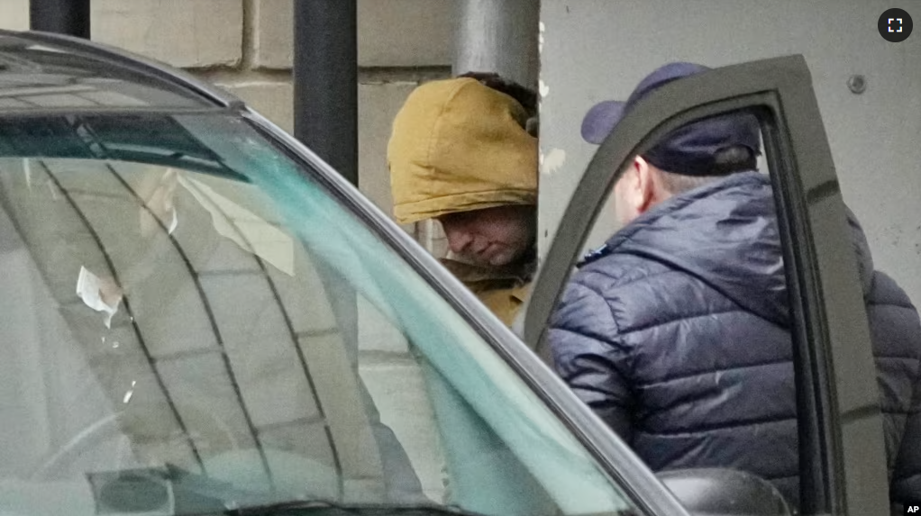 Wall Street Journal reporter Evan Gershkovich is escorted by officers from the Lefortovsky court to a bus, in Moscow, Russia, Thursday, March 30, 2023. (AP Photo/Alexander Zemlianichenko)