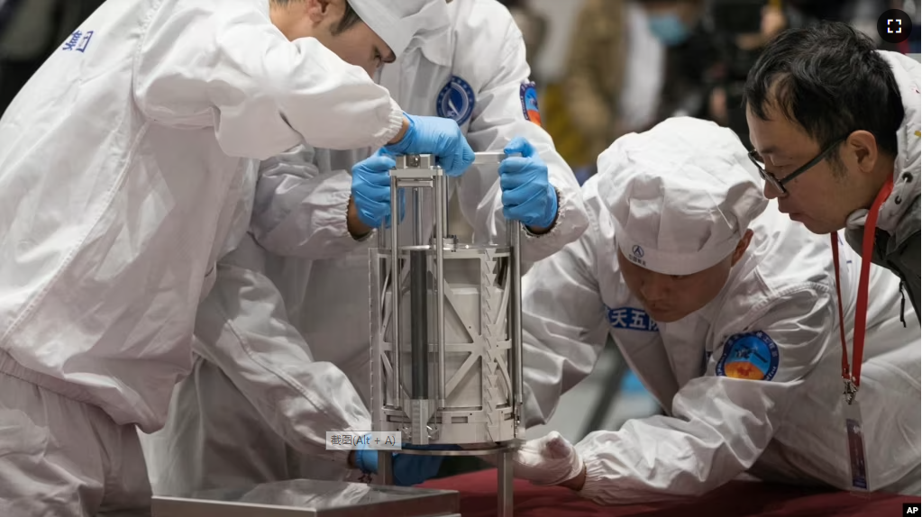 FILE - In this Thursday, Dec. 17, 2020 photo provided by China's Xinhua News Agency, technicians prepare to weigh a container carrying moon samples retrieved by China's Chang'e 5 lunar lander in Beijing. (Jin Liwang/Xinhua via AP, File)