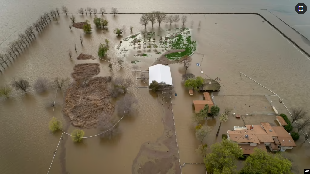 A home sits in rising floodwaters after a levee break caused extensive flooding around Corcoran, Calif., on Tuesday, March 21, 2023. (Carlos Avila Gonzalez/San Francisco Chronicle via AP, File)