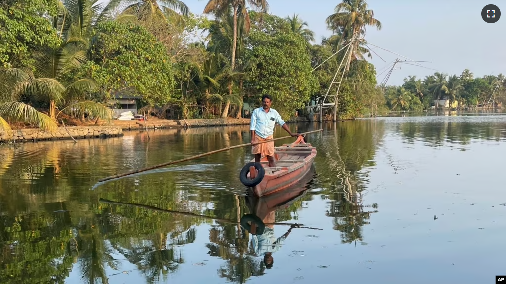 A man travels to help people get clean water in Kochi, Kerala state, India, on March 1, 2023. Saltwater's intrusion into freshwater means residents can no longer depend on ponds and wells for the water they need to drink, cook and wash. (Uzmi Athar/Press Trust of India via AP)