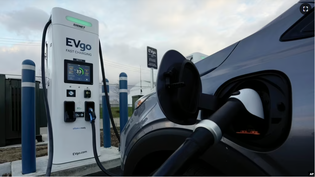 FILE - An electric vehicle charges at an EVgo fast charging station in Detroit on Nov. 16, 2022. (AP Photo/Paul Sancya, File)