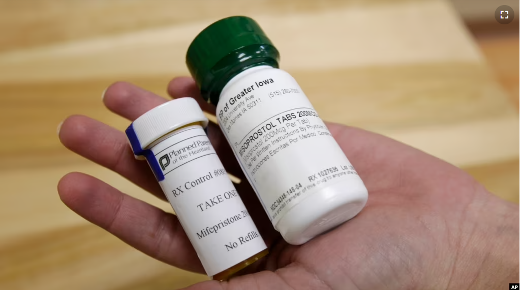 FILE - Bottles of abortion pills mifepristone, left, and misoprostol, right, at a health center in Des Moines, Iowa, Sept. 22, 2010. A federal appeals court has preserved access to an abortion drug for now with some restrictions. (AP Photo/Charlie Neibergall, File)