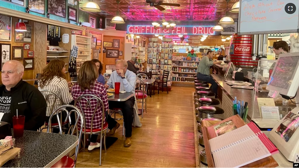 Customers dine at Griffith & Feil Drug on Thursday, March 30, 2023, in Kenova, W. Va. The pharmacy opened in 1892 with a soda fountain counter that was taken out in 1957 but reopened in 2004. (AP Photo/John Raby)