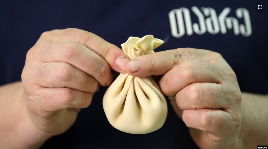 A cook demonstrates the preparation of the traditional Georgian dish Khinkali at a restaurant in Tbilisi, Georgia, April 11, 2023. (REUTERS/Irakli Gedenidze)