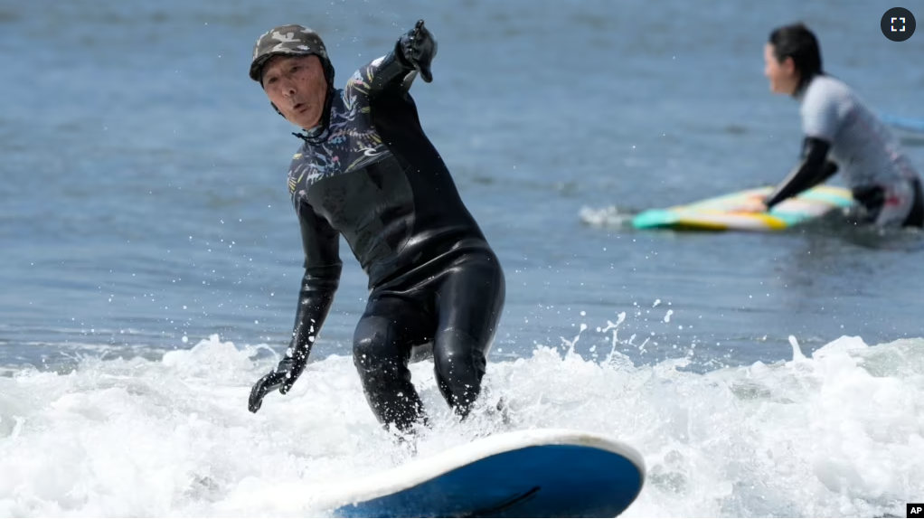 Seiichi Sano, an 89-year-old Japanese man, rides a wave at Katase Nishihama Beach, Thursday, March 30, 2023, in Fujisawa, south of Tokyo. Sano, who turns 90 later this year, has been recognized by the Guinness World Records as the oldest male to surf. (AP Photo/Eugene Hoshiko)