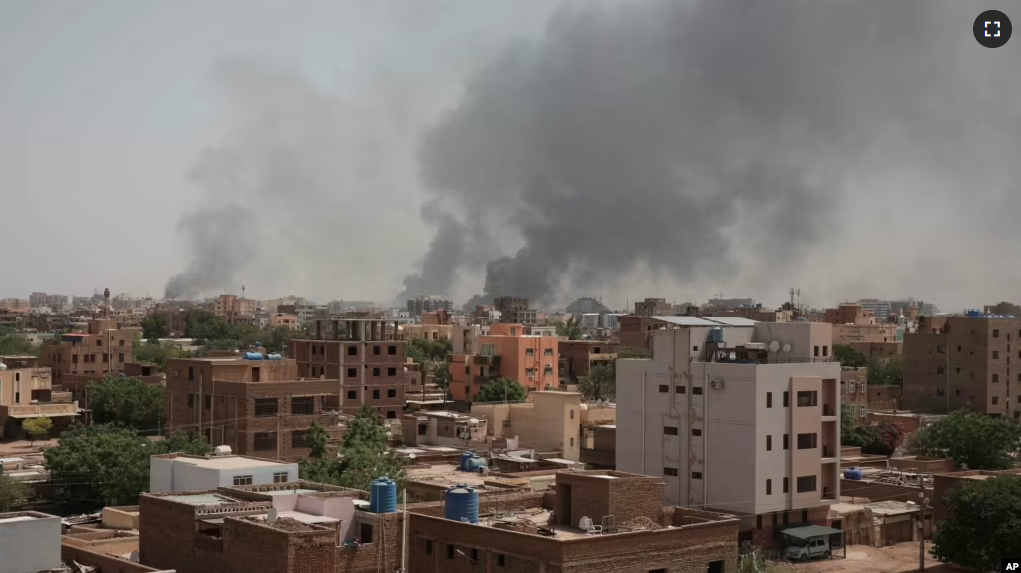 Smoke rises from a central neighborhood of Khartoum, Sudan, Sunday, April 16, 2023, after dozens have been killed in two days of intense fighting. (AP Photo/Marwan Ali)