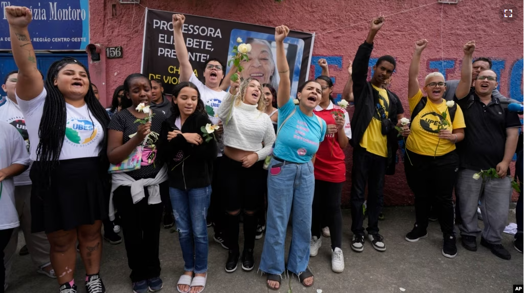 FILE - Students of the Thomazia Montoro public school shout for peace and against violence during a vigil at their school in Sao Paulo, Brazil, March 28, 2023. (AP Photo/Andre Penner, File)