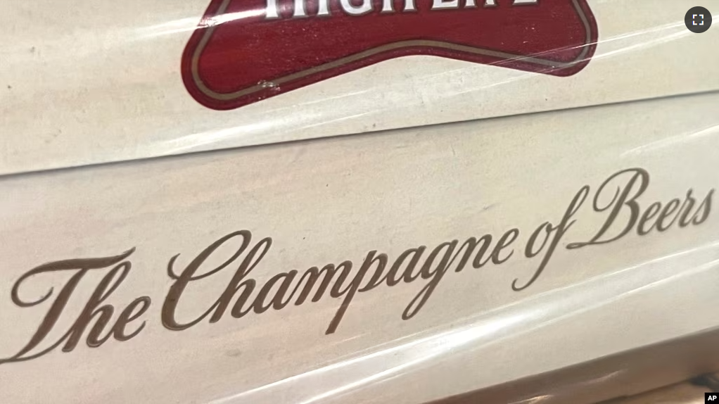 In this image provided by Comite Champagne, a label on the side of a carton of Miller High Life beer at the Westlandia plant in Ypres, Belgium on April 17, 2023. (Comite Champagne via AP)