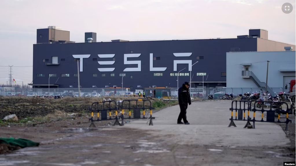 FILE - A Tesla sign is seen on the Shanghai Gigafactory of the U.S. electric car maker before a delivery ceremony in Shanghai, China January 7, 2020. (REUTERS/Aly Song/File Photo)