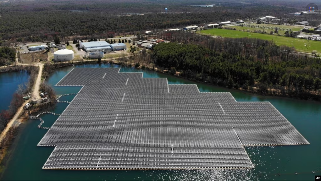 An array of solar panels float on top of a water storage pond in Sayreville, N.J., Monday, April 10, 2023. (AP Photo/Seth Wenig)