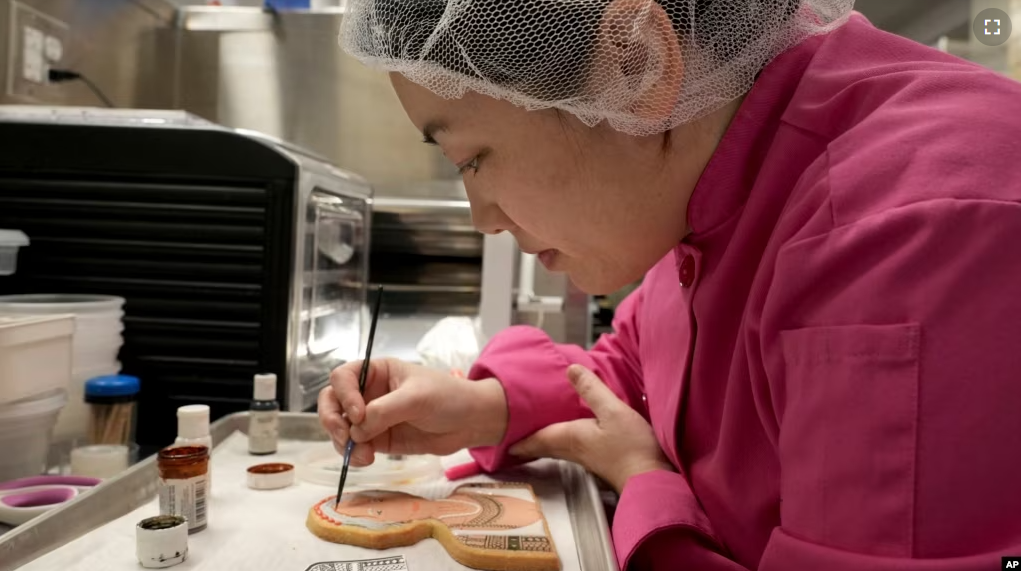 Jasmine Cho works on a cookie portrait of Filipina mambabatok tattoo artist Apo Whang-Od in Pittsburgh, Pa., May 3, 2023. (AP Photo/Matt Freed)