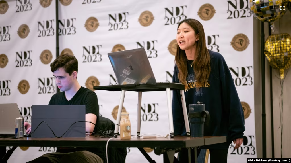 Kelly Phil (standing) and teammate Rafael Pierry from the University of Michigan debate during the final round of the National Debate Tournament, Monday, April 4 in Chantilly, Virginia. (Photo Courtesy of Claire Brickson)