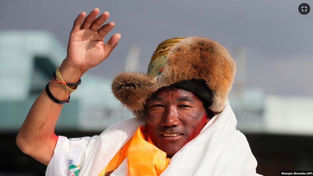 FILE - In this May 20, 2018 photo, Nepalese Sherpa guide, Kami Rita waves as he arrives in Kathmandu, Nepal. Rita regained his title with the most climbs of Mount Everest after scaling the peak for the 27th time on Wednesday. (AP Photo/Niranjan Shrestha,)