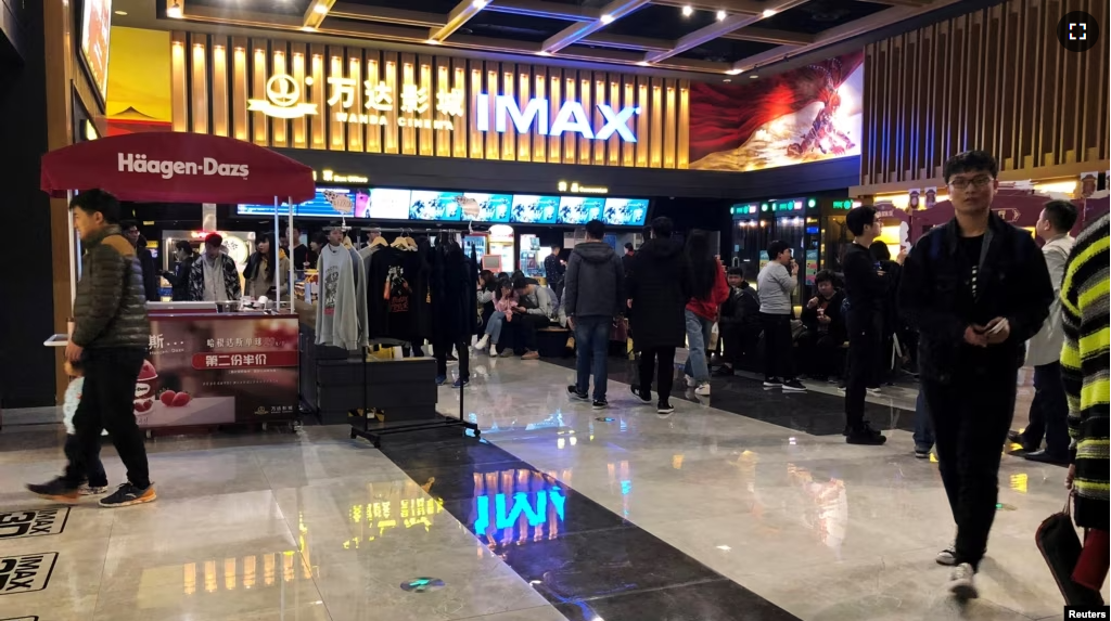 FILE - People wait for movie screening at an IMAX theatre inside the Wanda Plaza in Xinxiang, Henan province, China March 23, 2018. (REUTERS/Stella Qiu/File Photo)