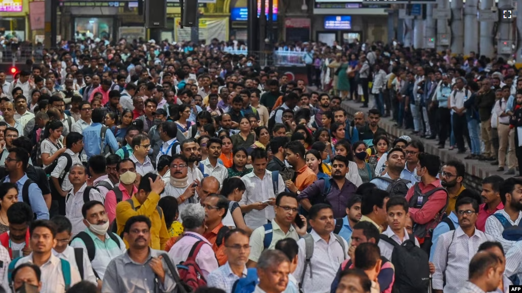 FILE - People wait for their train on platforms at the Chhatrapati Shivaji Terminus (CST) railway station Mumbai, India, April 19, 2023. (Photo by Punit PARANJPE / AFP)