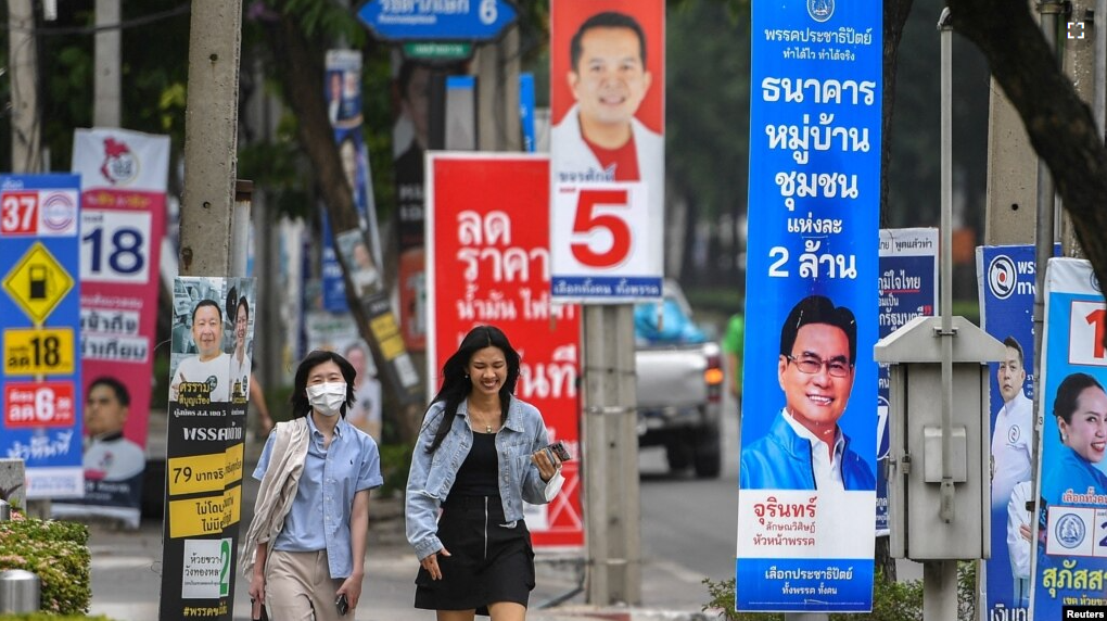 FILE - People walk past electoral campaign posters as Thailand will hold general elections on May 14, in Bangkok, Thailand, April 26, 2023. (REUTERS/Chalinee Thirasupa/File Photo)