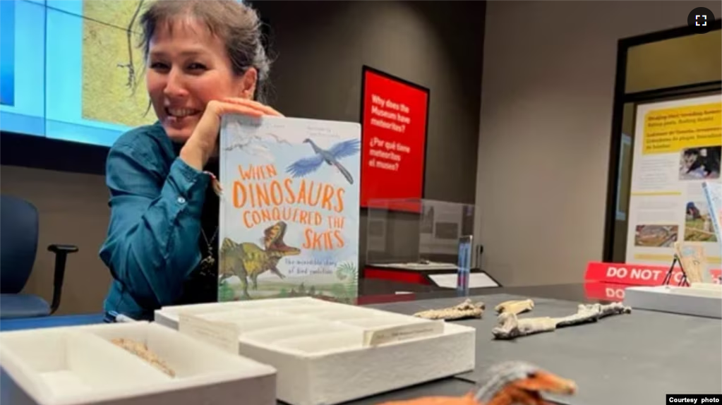 Writer and paleontologist Jingmai O’Connor holds WHEN DINOSAURS CONQUERED THE SKIES , published by The Quarto Group (Photo: Lisa Fielding)