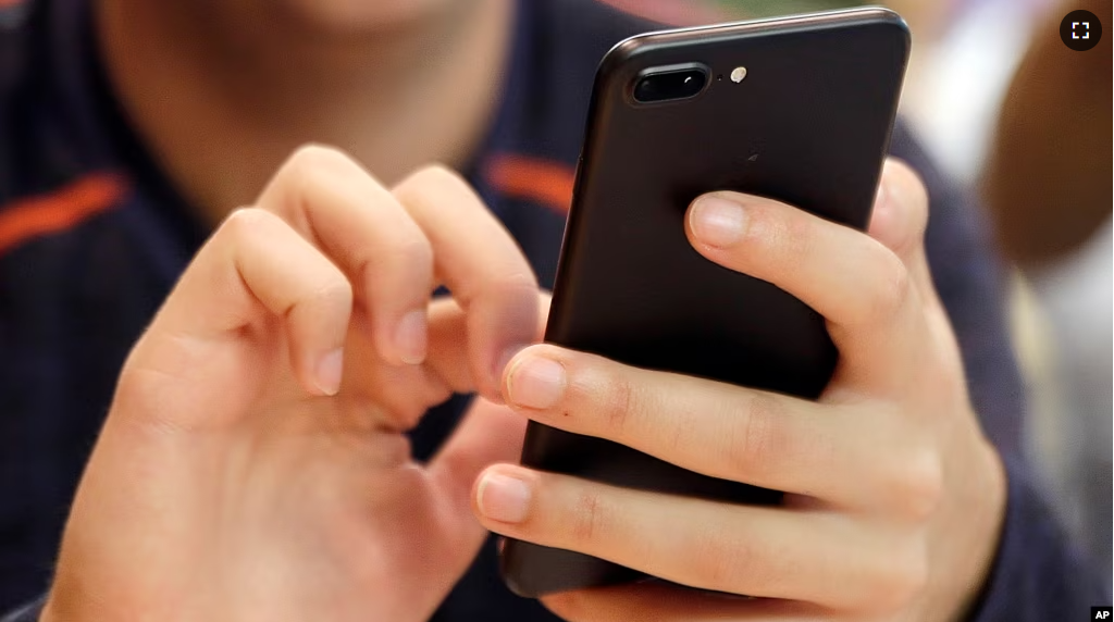 A unidentified person uses a smartphone in Chicago, Sept. 16, 2017. (AP Photo, File)