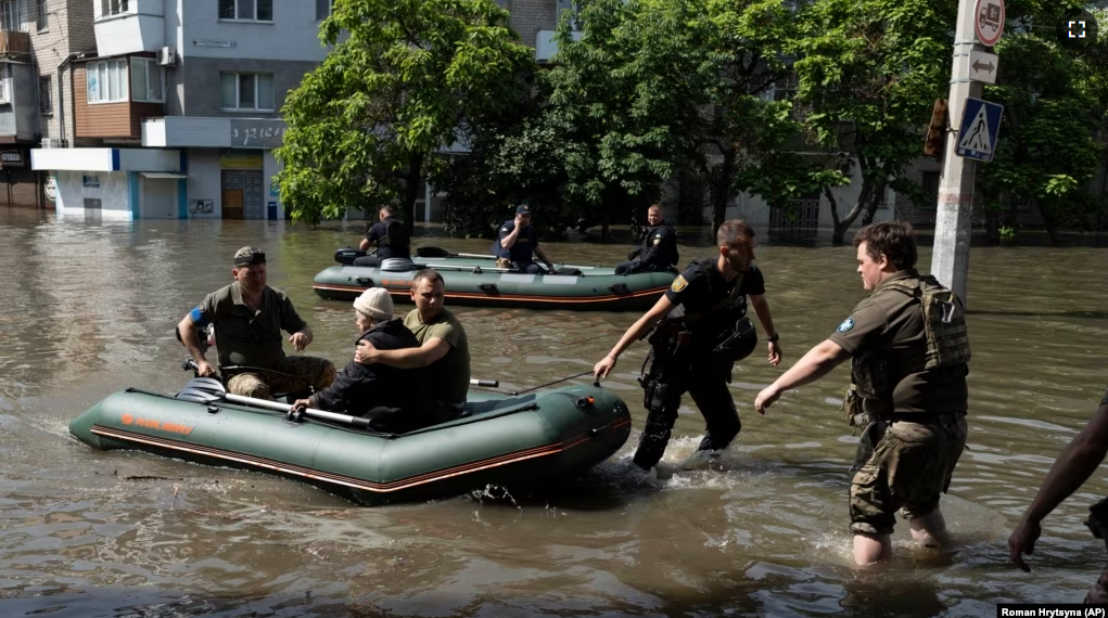 A woman is evacuated from a flooded neighborhood in Kherson, Ukraine, Wednesday, June 7, 2023. (AP Photo/Roman Hrytsyna)