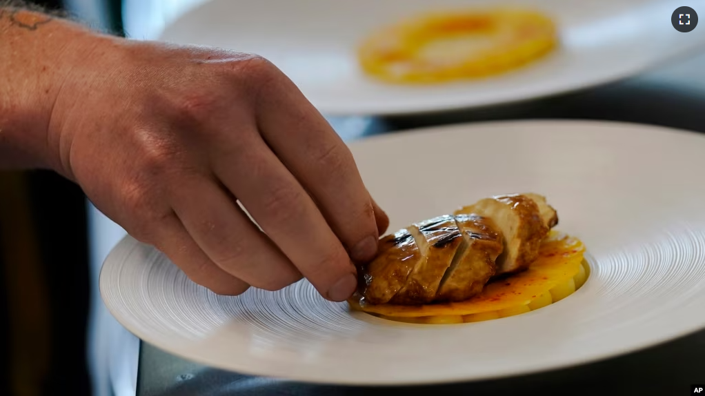 Chef Zach Tyndall prepares Good Meat's cultivated chicken at the Eat Just office in Alameda, California, June 14, 2023.(AP Photo/Jeff Chiu)