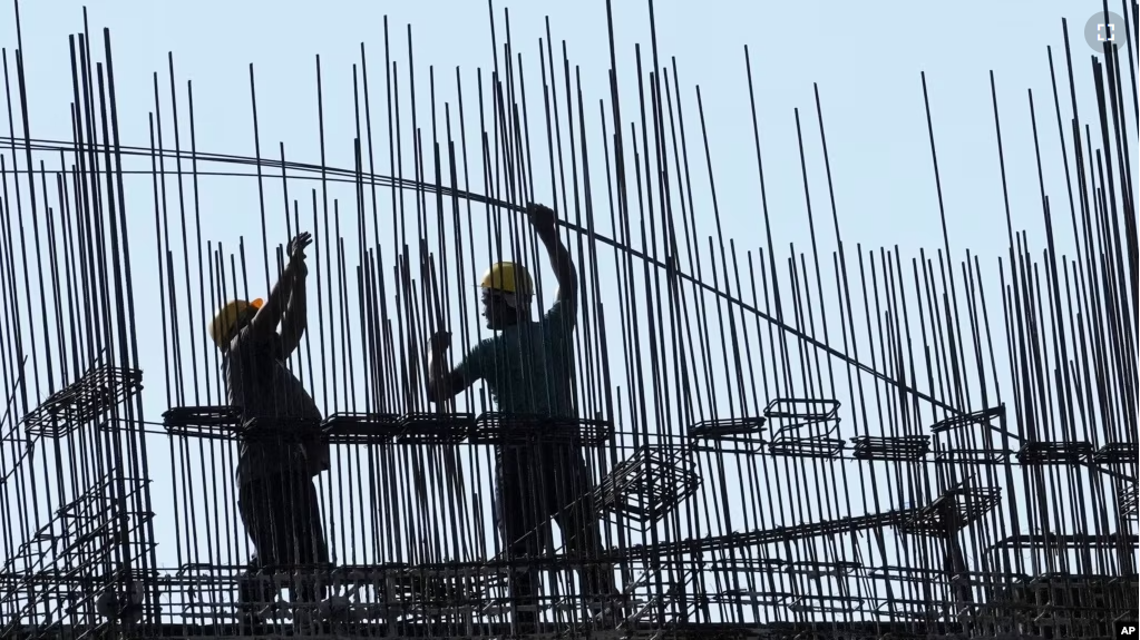 Construction laborers work at under construction residential building in Mumbai, India, Wednesday, May 31, 2023. (AP Photo/Rajanish Kakade)