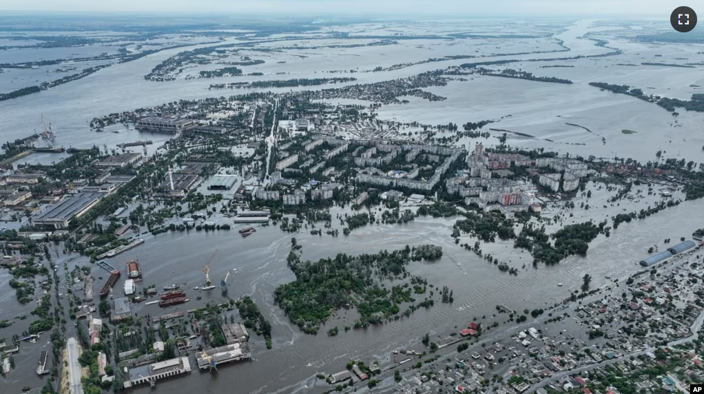 Houses are seen underwater and polluted by oil in a flooded neighbourhood in Kherson, Ukraine, Saturday, June 10, 2023. (AP Photo)