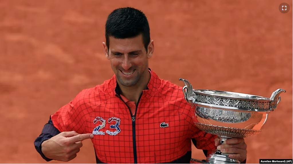 Serbia's Novak Djokovic holds the trophy after winning the men's singles final match of the French Open tennis tournament against Norway's Casper Ruud in three sets, 7-6, (7-1), 6-3, 7-5, at the Roland Garros stadium in Paris, Sunday, June 11, 2023. (AP Photo/Aurelien Morissard)