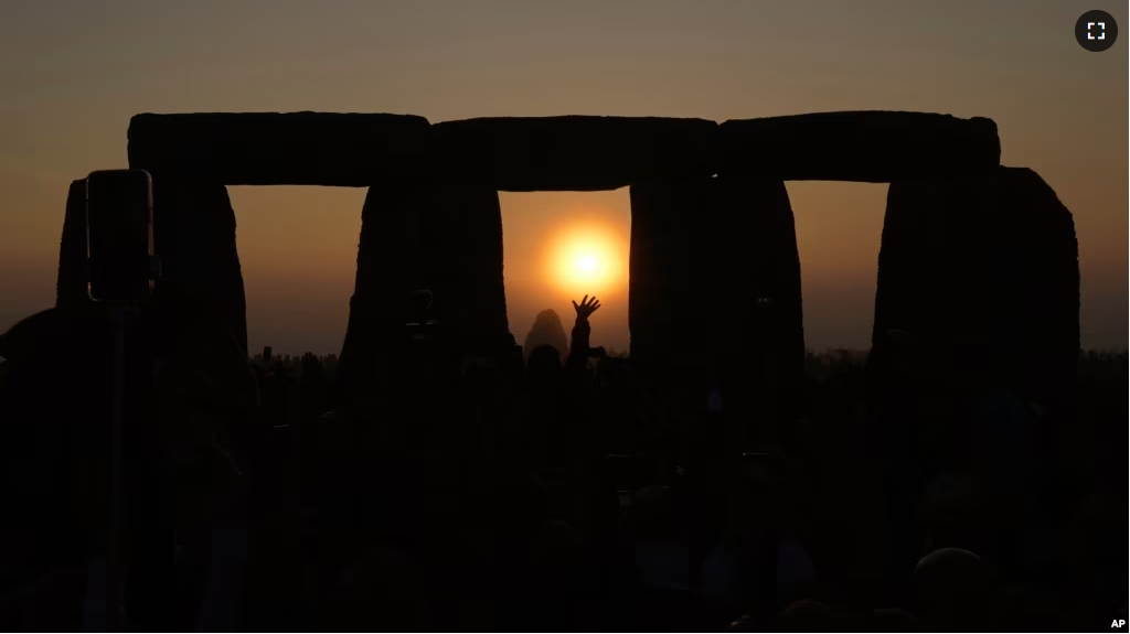 People gather at Stonehenge to celebrate the Summer Solstice, the longest day of the year, near Salisbury, England, June 21, 2023. (AP Photo/Kin Cheung)