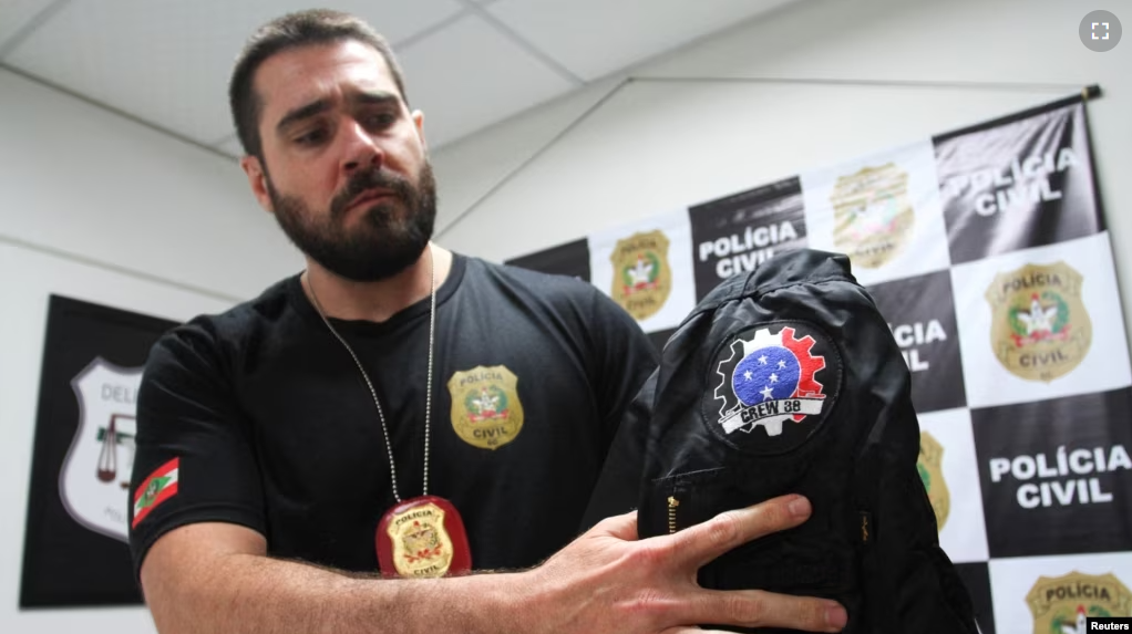 Police detective Arthur Lopes shows a jacket seized from a neo-Nazi group who call themselves Crew 38 in Florianopolis, Santa Catarina state, Brazil April 24, 2023. (REUTERS/Cristiano Estrela)