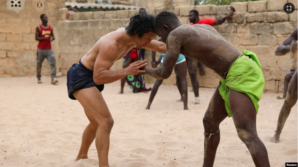 Shogo Uozumi, also known as Songo Tine, 29 years old, wrestles with Baye Ibra at the Samba Dia stable in the Diakhao neighbourhood, in Thies, Senegal, May 26, 2023. (REUTERS/Ngouda Dione)