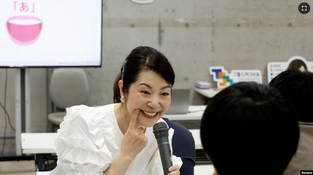 FILE - Smile coach Keiko Kawano teaches students at a smile training course at Sokei Art School in Tokyo, Japan, May 30, 2023. REUTERS/Kim Kyung-Hoon