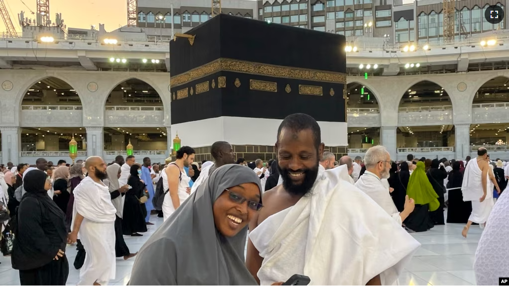 Somalian pilgrims prepare for a selfie in front of the Kaaba, the cubic building at the Grand Mosque, during the annual hajj pilgrimage in Mecca, Saudi Arabia, on June 26, 2023.(AP Photo/Amr Nabil)