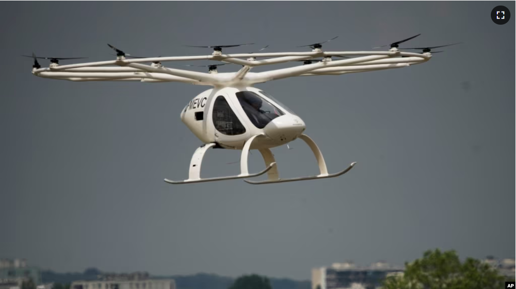 The Volocopter 2X, an electric vertical takeoff and landing multicopter, performs a demonstration flight during the Paris Air Show in Le Bourget, north of Paris, France, Monday, June 19, 2023. (AP Photo/Lewis Joly)