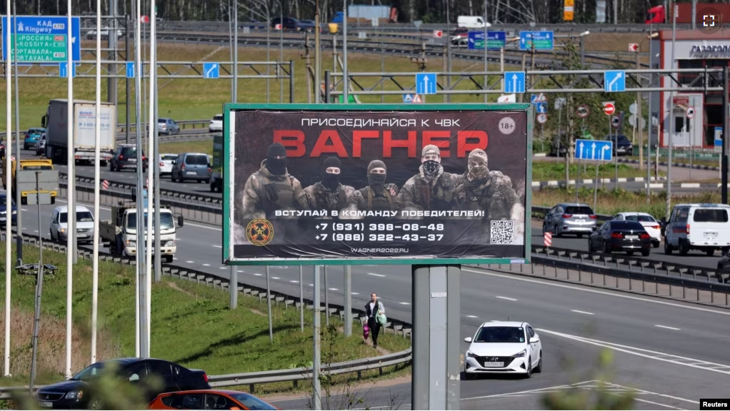 An advertising board, which promotes service in Wagner private mercenary group, is on display on the roadside on the outskirts of Saint Petersburg, Russia, June 7, 2023. (REUTERS/Anton Vaganov)