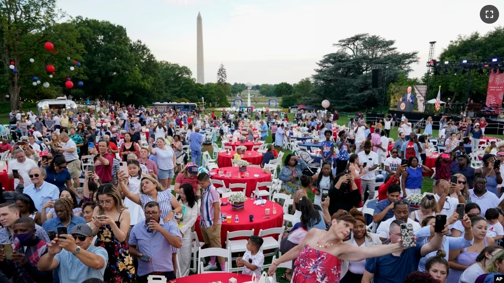 FILE - Attendees listen as President Joe Biden speaks during an Independence Day celebration on July 4, 2021. (AP Photo)