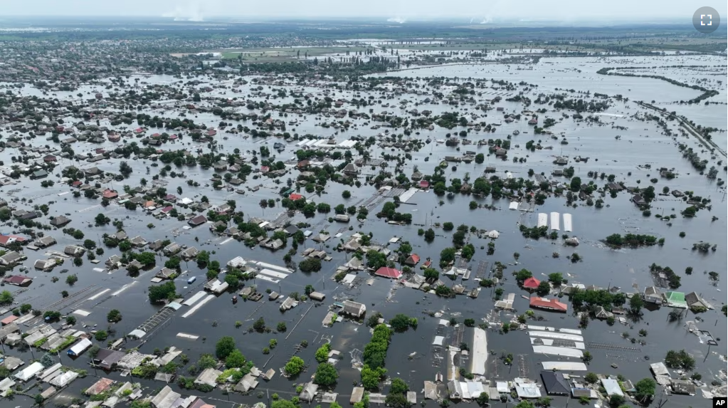 FILE - Houses are seen underwater in the flooded town of Oleshky, Ukraine, on June 10, 2023. (AP Photo, File)