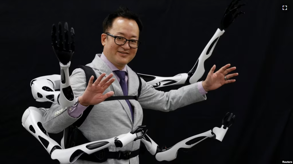 Masahiko Inami of the University of Tokyo poses with the wearable "Jizai Arms" robot arms at his lab during its demonstration in Tokyo, Japan, June 22, 2023. (REUTERS/Kim Kyung-Hoon)