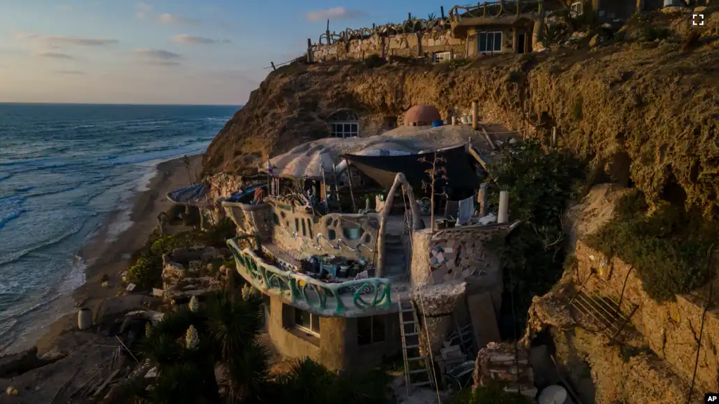 Nissim Kahlon's home, chiseled out of the sandstone cliffs, overlooks the Mediterranean sea in Herzliya, Israel, Wednesday, June 28, 2023. (AP Photo/Ariel Schalit)