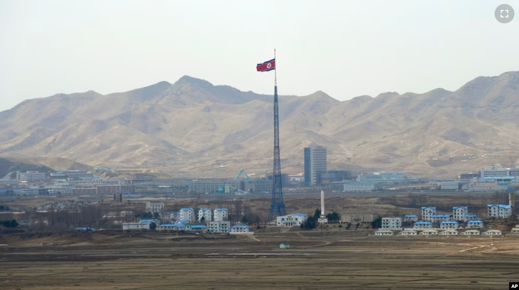 FILE - North Korea's flag flies on a tower high above the village of Ki Jong Dong, as seen from Observation Post Ouellette in the Demilitarized Zone, DMZ, the tense military border between the two Koreas, in Panmunjom, March 25, 2012. (AP Photo/Susan Walsh, File)