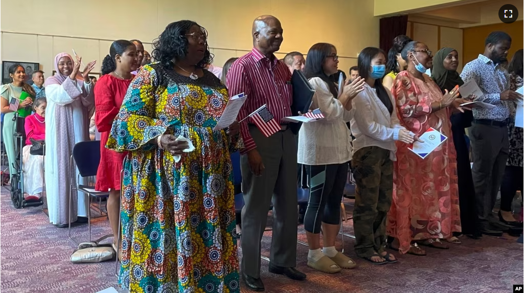 FILE - People become U.S. citizens during a naturalization ceremony at Mount Zion Temple in St. Paul, Minn., on June 21, 2023.(AP Photo/Trisha Ahmed)