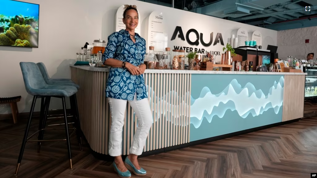 Roia Jabari, managing director of AQUA Water Bar by LUQEL poses at her store in Dubai, United Arab Emirates on July 11, 2023. (AP Photo/Kamran Jebreili)