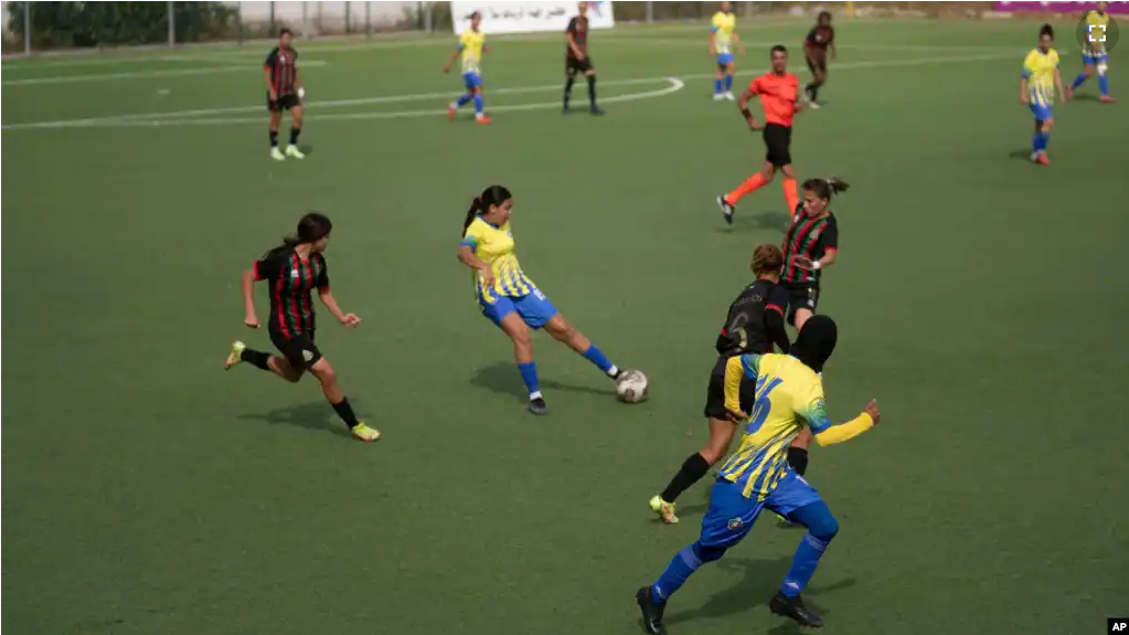 Women footballers compete in a soccer match between ASFAR and ASDCT Ain Atiq, in Morocco's professional women league, in Rabat, Morocco, Wednesday, May 17, 2023. (AP Photo/Mosa'ab Elshamy)