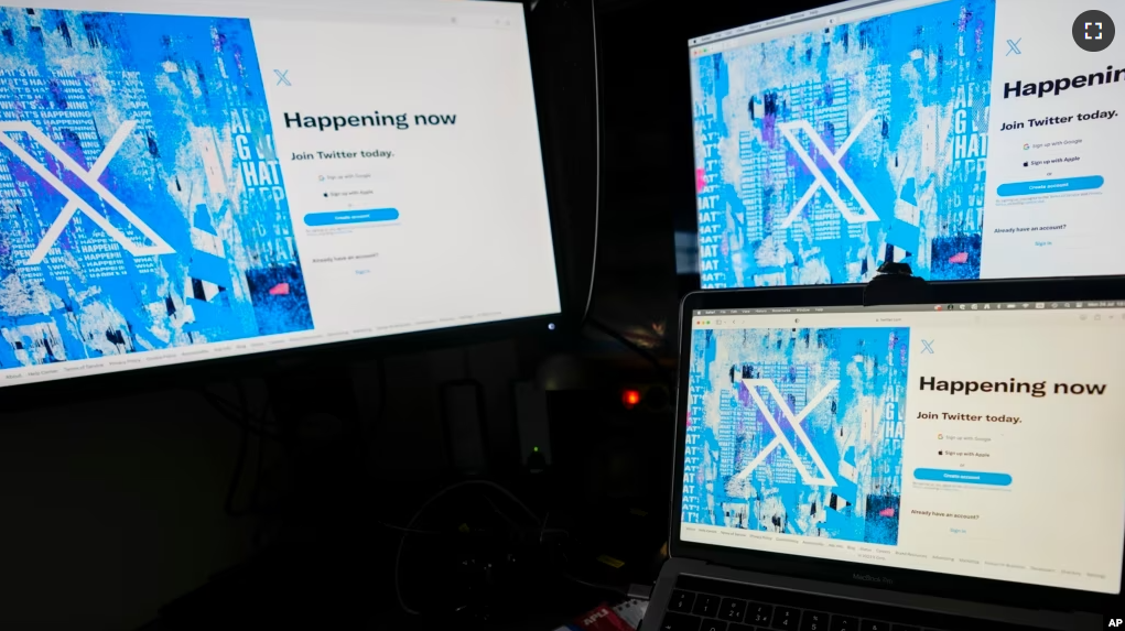 A view of a lap top and monitors showing the Twitter signing in page displaying the new logo, in Belgrade, Serbia, Monday, July 24, 2023. (AP Photo/Darko Vojinovic)