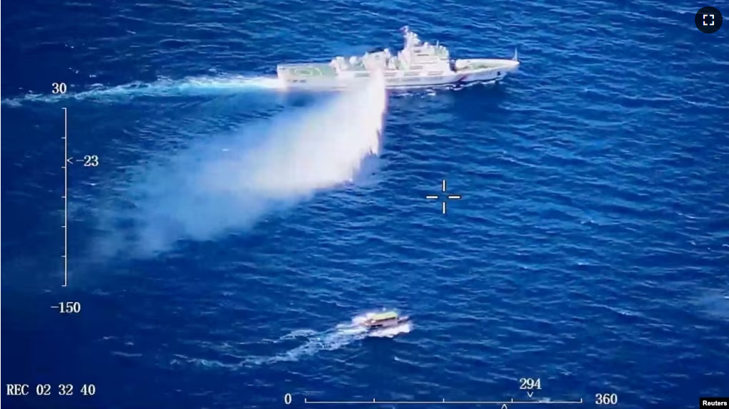 A Chinese Coast Guard ship launches what the Coast Guard says is a warning water cannon spray in the direction of a Philippine vessel at an unknown location at sea in this screen grab taken from a video released on August 8, 2023. (China Coast Guard/Handout via REUTERS)