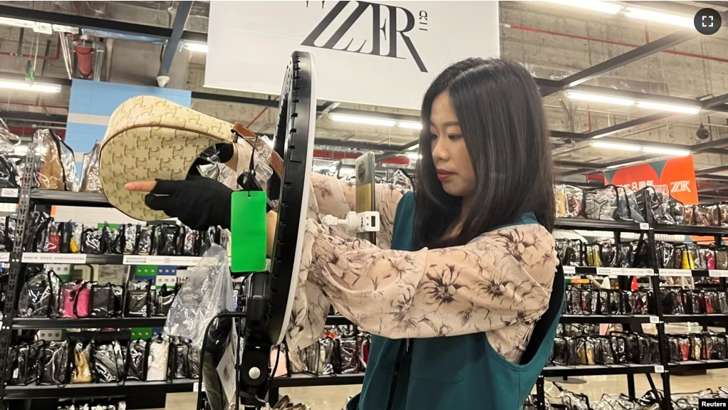 A host promotes a bag during a live stream at luxury e-commerce platform ZZER in Shanghai, China July 5, 2023. (REUTERS/Xihao Jiang)