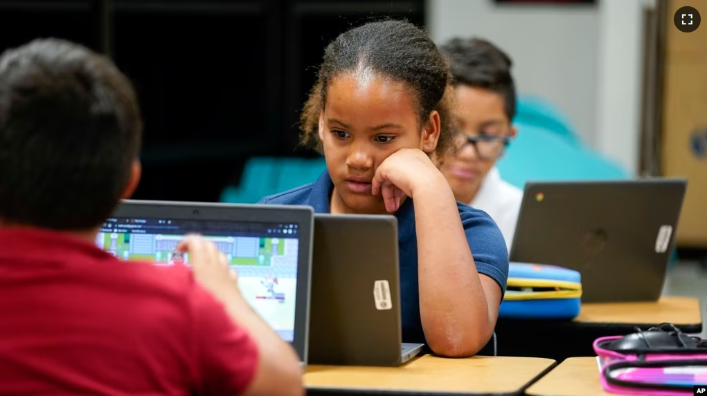 FILE - Aaliyah Ibarra and fellow students work on their computers during the last week of classes at Frye Elementary School in Chandler, Ariz., Tuesday, May 23, 2023. (AP Photo/Darryl Webb)