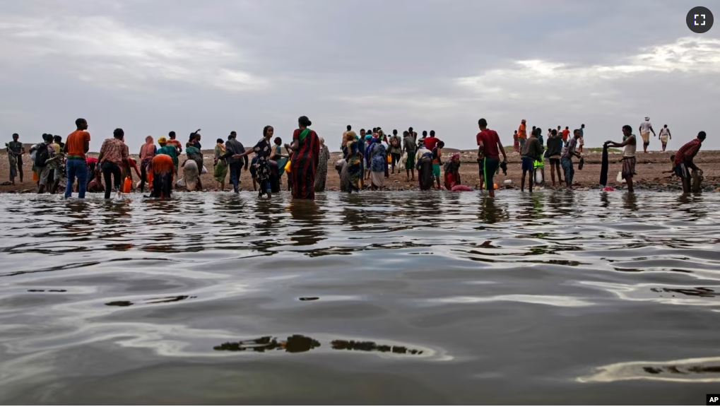 In this file photo, Ethiopian migrants walk on the shores of Ras al-Ara, Lahj, Yemen, after disembarking from a boat, July 26, 2019. (AP Photo/Nariman El-Mofty, File)