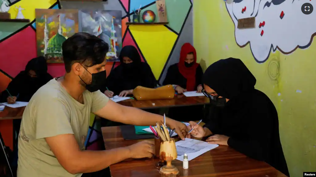 Khushi talks to her art teacher Zaheen in an art studio in Mazar-i-Sharif, Afghanistan, August 6, 2023. (REUTERS/Ali Khara)