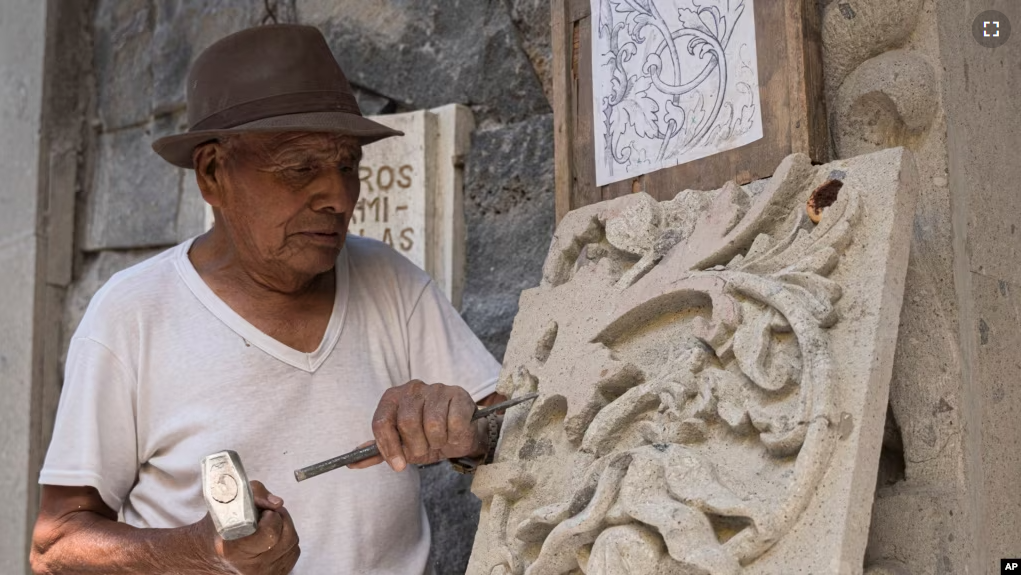 Master stone carver Tomás Ugarte sculpts quarry at the cemetery in the Mexico City borough of Chilmalhuacan, once the ancient village of Xochiaca, Sunday, July 2, 2023. (AP Photo/Aurea Del Rosario)