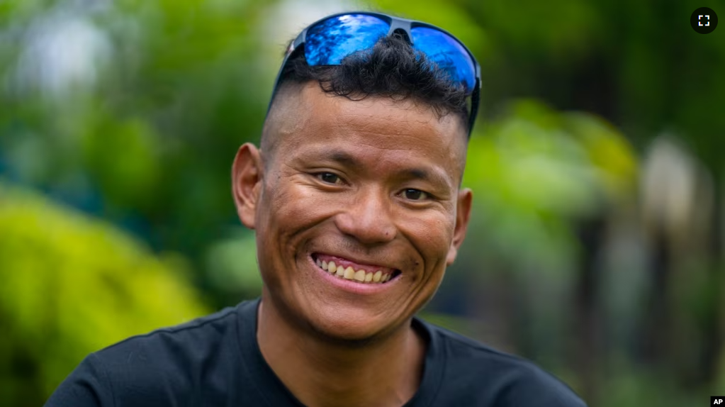 Nepali climbing guide Tenjen Sherpa, 35, poses during an interview with the Associated Press in Kathmandu, Nepal, Wednesday, August 9, 2023. (AP Photo/Niranjan Shrestha)